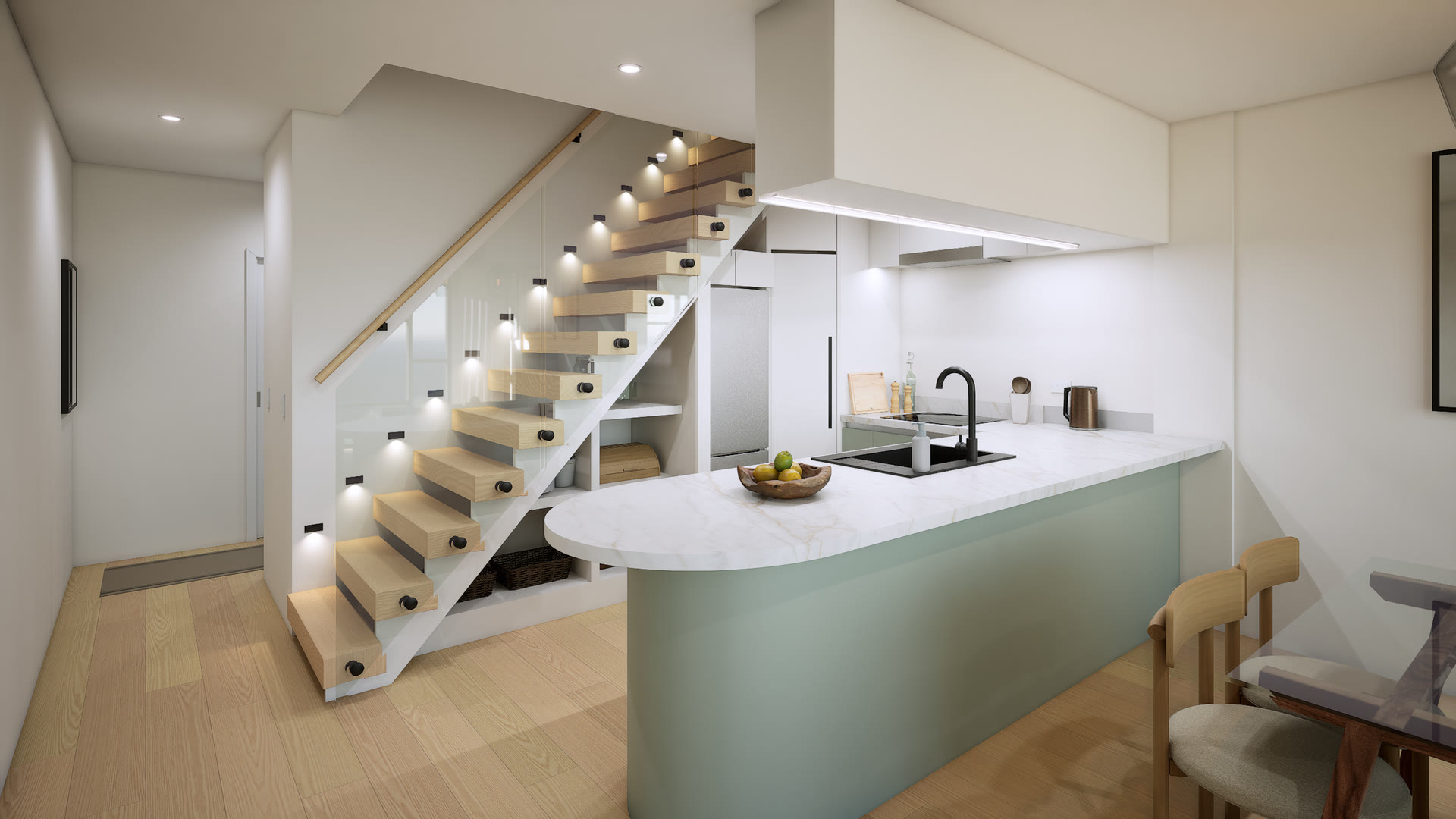 Kitchen with a rounded sage-green island and marble top beside an open timber stair with lit treads