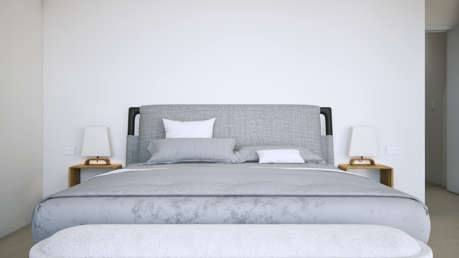 Bedroom with an upholstered grey bed, timber bedside tables and linen lamps