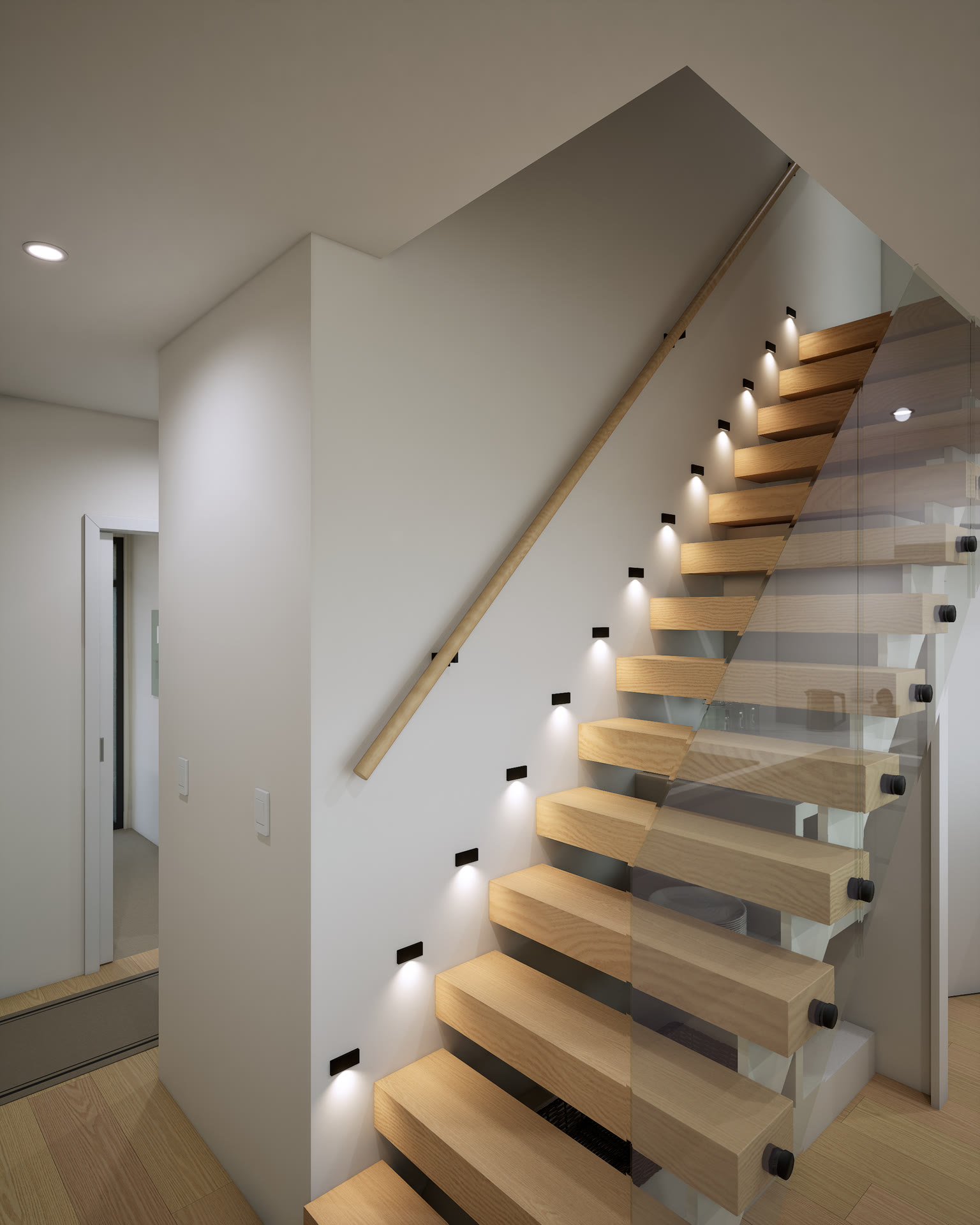Close-up of the floating timber stair treads, each lit by a small wall light, behind a glass balustrade
