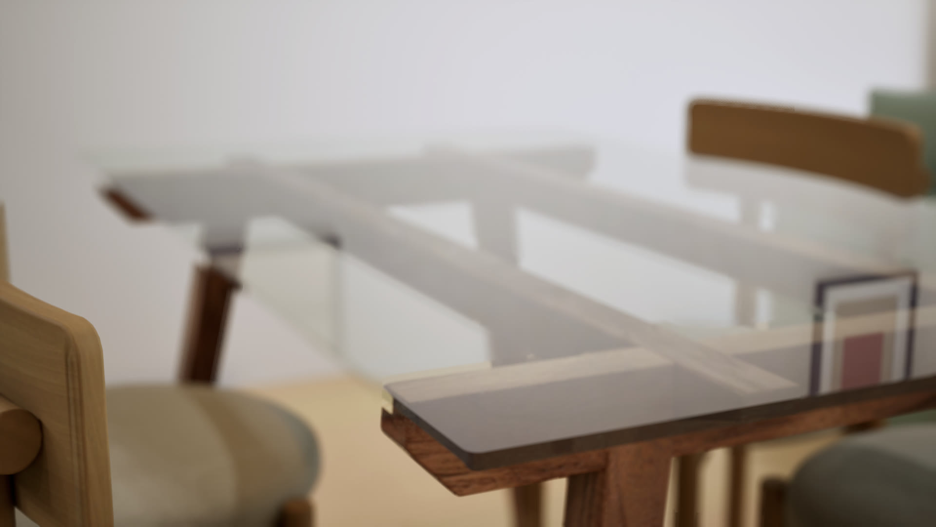 Shallow-focus close-up of the glass-topped dining table's timber frame