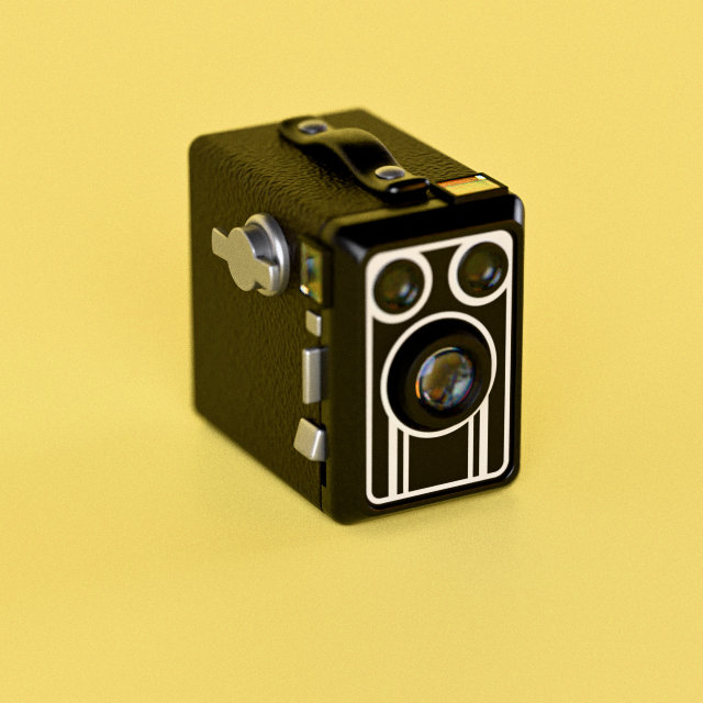 A black 1920s-style box camera with an Art Deco face, on yellow