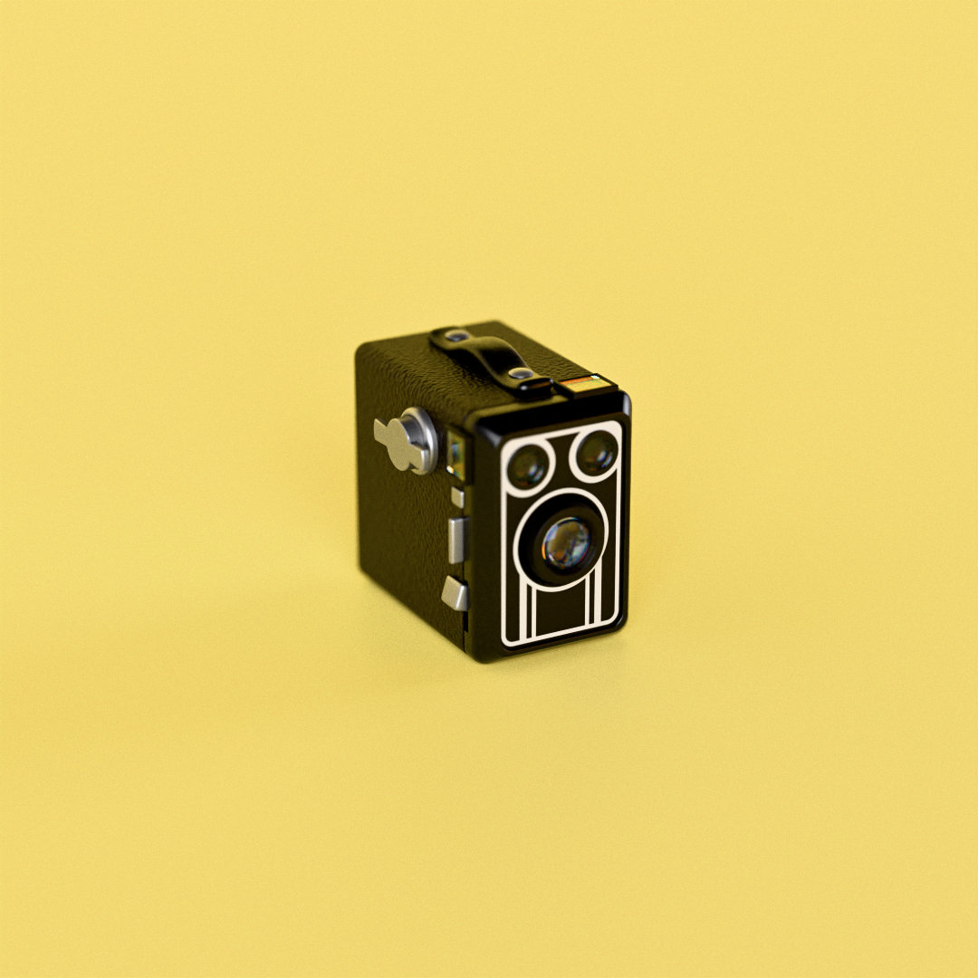 The box camera: black leatherette, a winding key on the side and a strap handle on top
