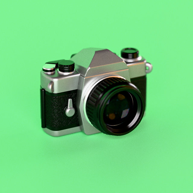 A chrome and black 1970s-style SLR, on green