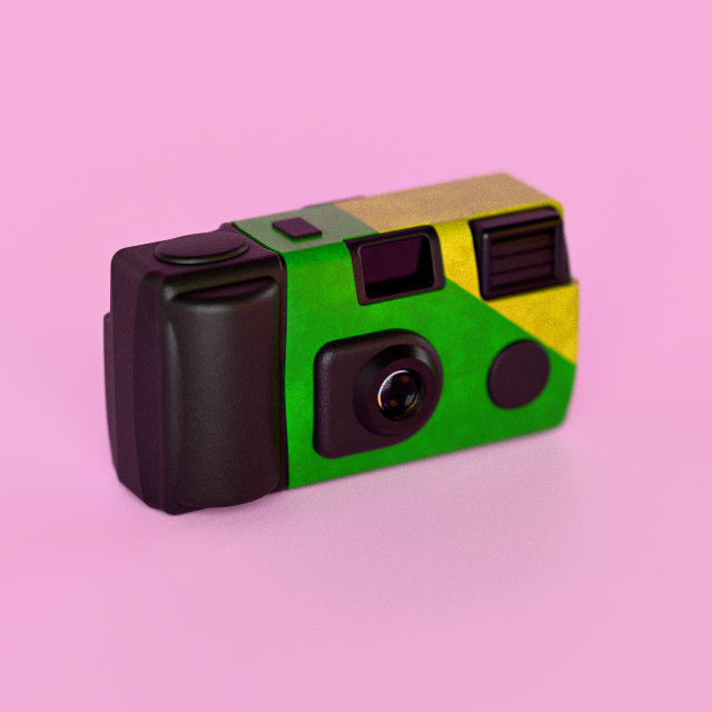 A 1990s-style disposable camera in a green and yellow wrap, on pink