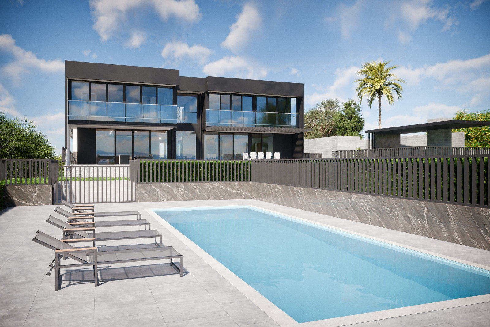 The rear of the house across a pool terrace with sun loungers